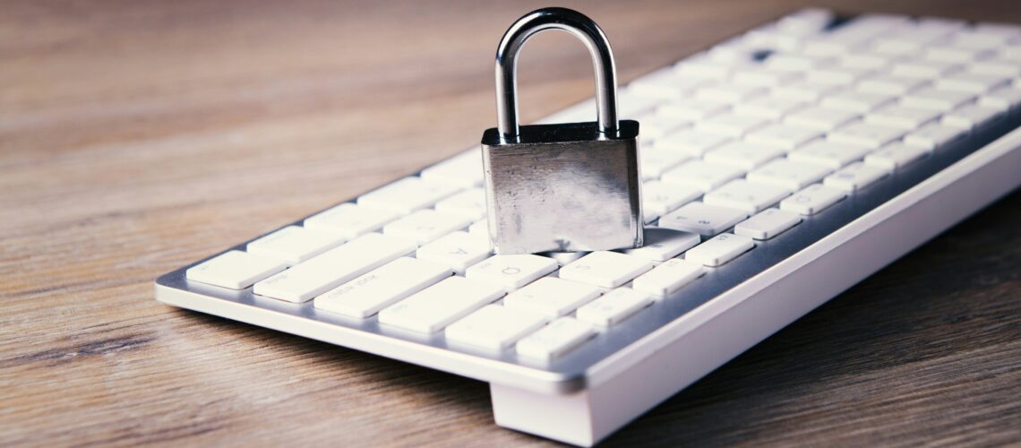 a computer keyboard with a padlock on top of it