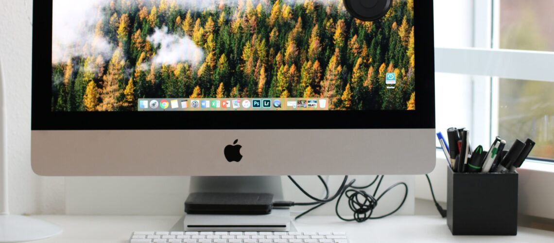 Free Turned on Silver Imac With Might Mouse and Keyboard Stock Photo