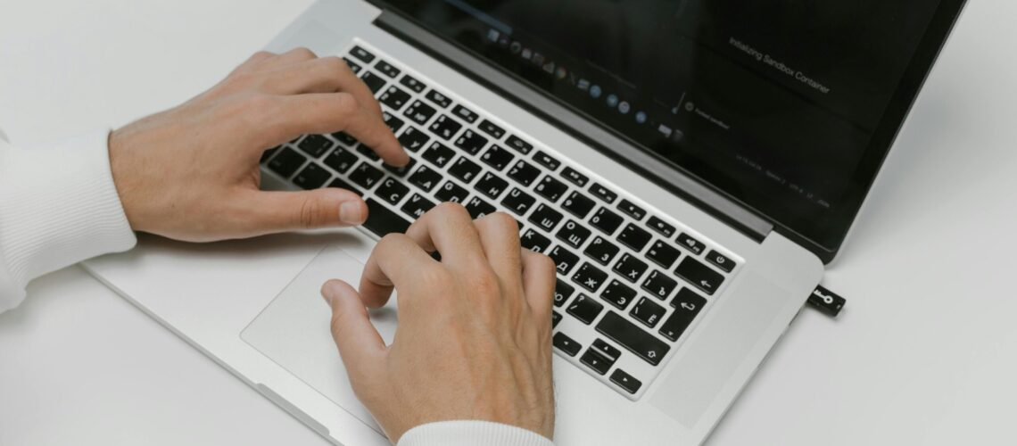 Free Hands on a Laptop Keyboard Stock Photo