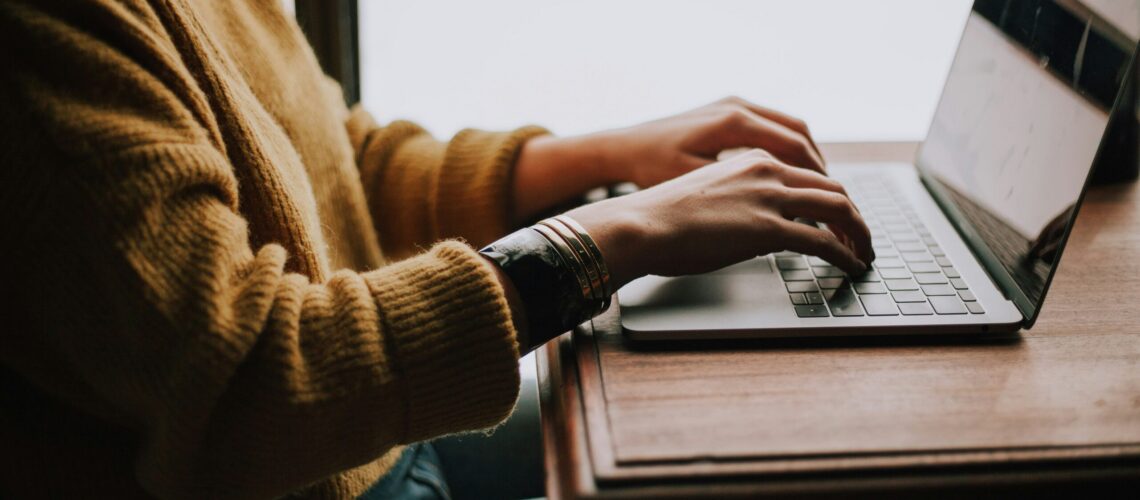 person sitting front of laptop