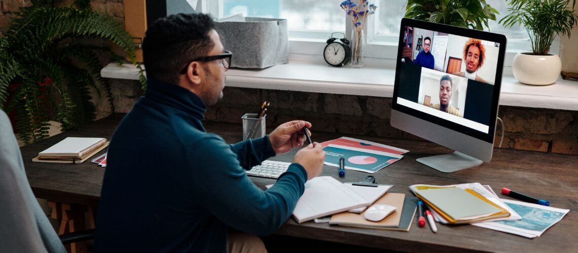 teacher-video-calling-with-his-students-using-a-computer